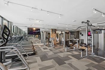 The gym with cardio equipment and weights at Bay Village 1 Apartment in Palmetto Bay, FL